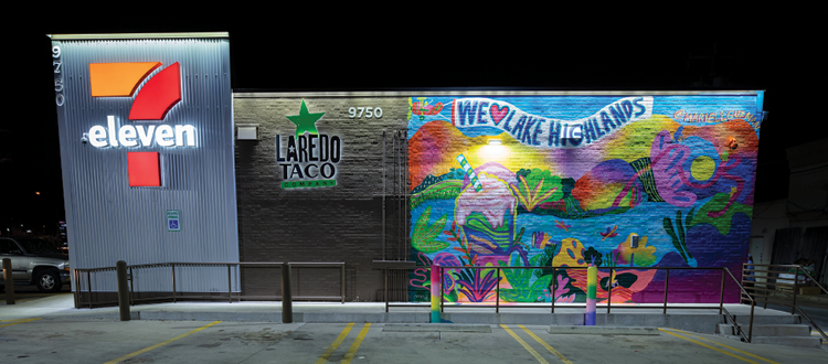 A colorful mural on the side of a 7-eleven says "We (heart) Lake Highlands."
